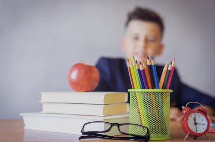 Kid with school supplies